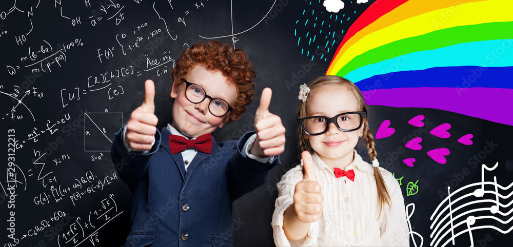 Two children giving thumbs up in front of a colorful blackboard with various drawings and text.